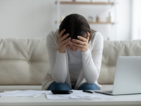 Frustrated young woman holding head in hands