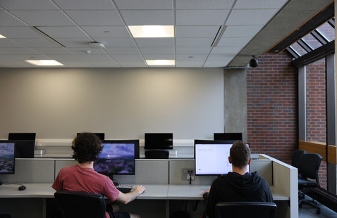 Two men sitting at computers in a computer lab