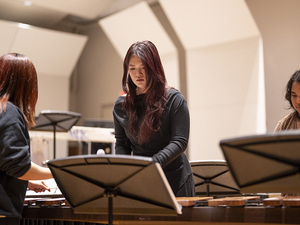 Group of three students playing on one marimba, Mount Holyoke College, McCulloch Auditorium.
