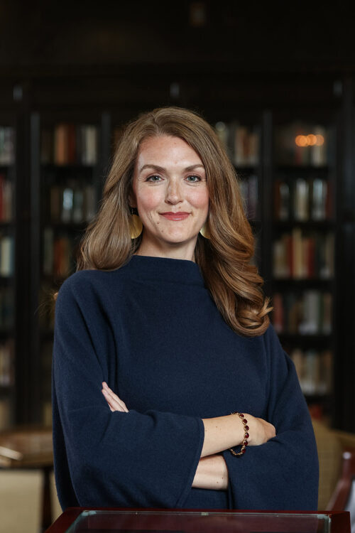 Headshot of speaker, Jennifer Frey, in front of blurred background of a bookcase