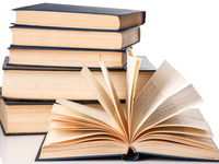 Stack of books with an open book in front.