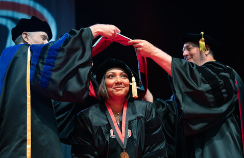 Female doctoral student at graduation