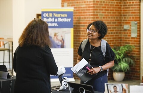 Prospective student talking with information session representative
