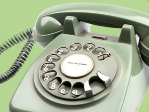 The photo displays a green rotary phone with lettering that reads "The Chatterbox."