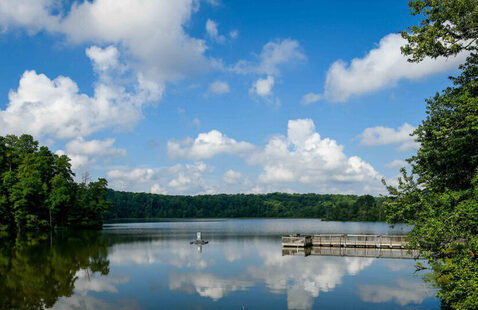 Lake Raleigh Pier with clouds reflecting in the water