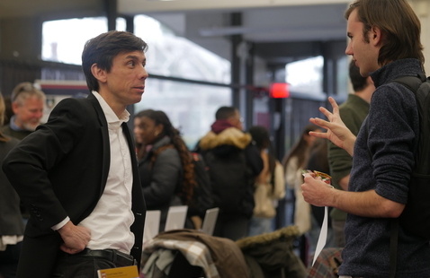 A man talks to a student during the Summer Opportunities & Funding Fair
