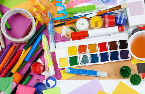 Mix of pens, paint, paper, and other creative art supplies