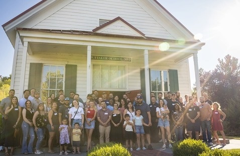 Alumni Chapter for Veterans pose in front of historic Huffaker School #9 in Reno.