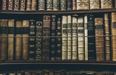 Photo of bookshelf filled with old, historical books