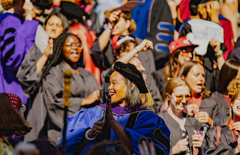 President Holley looks out at the Convocation crowd, many wearing colorful additions to their garb.