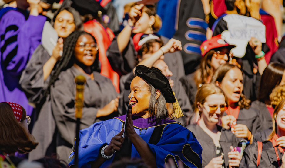 President Holley looks out at the Convocation crowd, many wearing colorful additions to their garb.