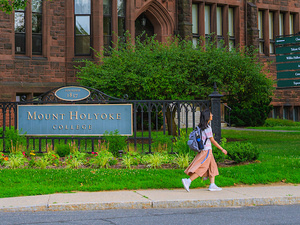 Student walks in front of Dwight Hall, summer 2024.