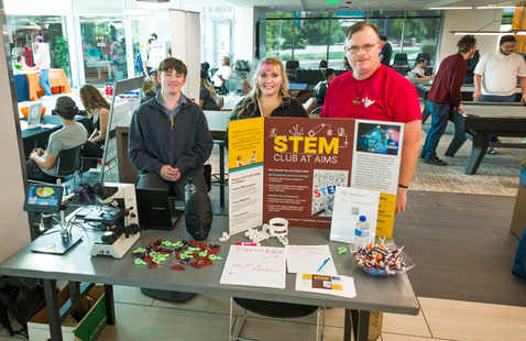 Photo of STEM Club members, poster, and table at Club Rush 2024