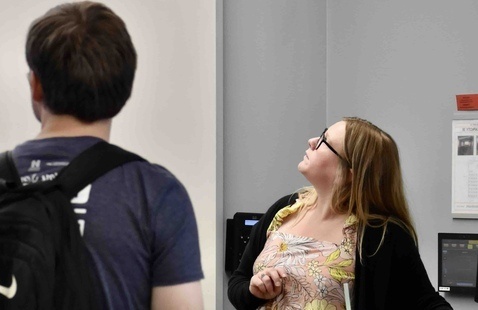 Student and instructor looking at projector screen.