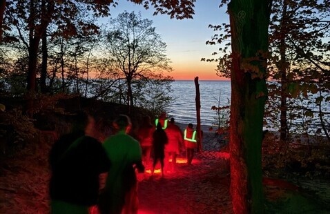 Guests attending the Full Moon Hike program and volunteers in orange vests