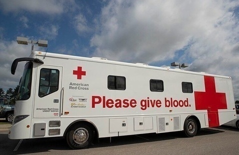Red Cross Bus that says Please Give Blood on it.