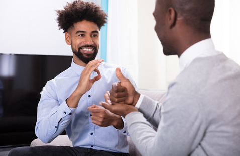Two people communicating with sign language