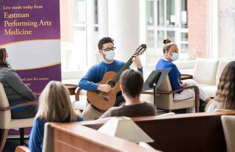guitarist plays in the lobby of Wilmot Cancer Center