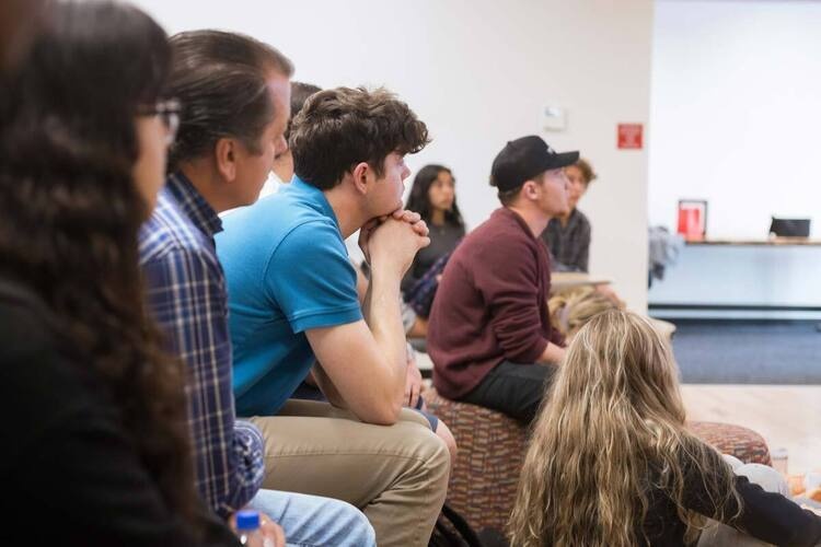 People in audience listing to speaker during a lecture