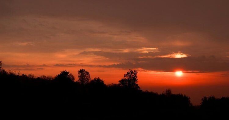 A sunset in the distance over mountains
