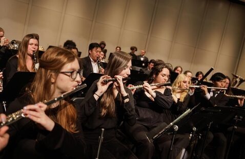 Wind Ensemble plays on stage during concert performance