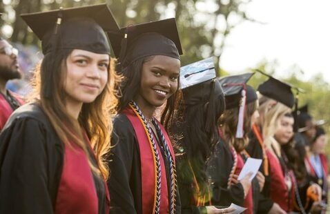 Smiling students in audience during commencement ceremony