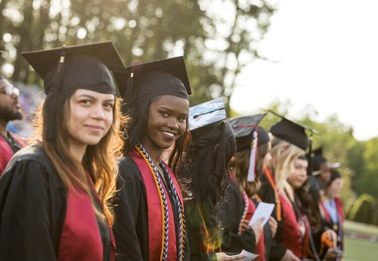 Smiling students in audience during commencement ceremony