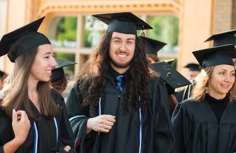 Group of graduating students preparing for commencement ceremony in Ashville