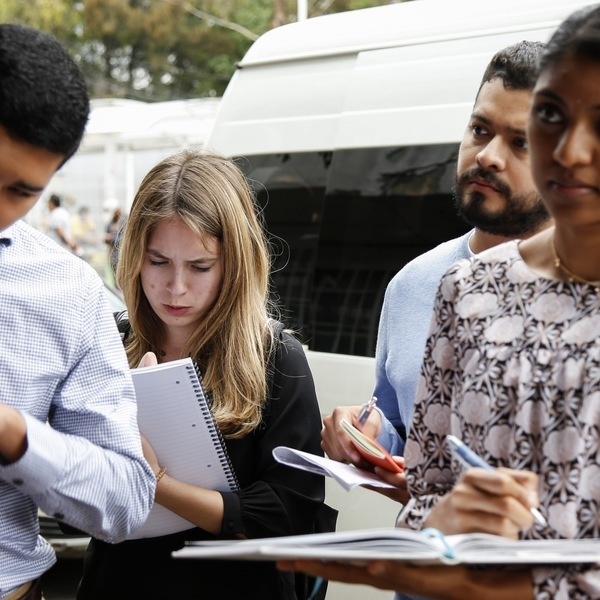 A group of students writing notes