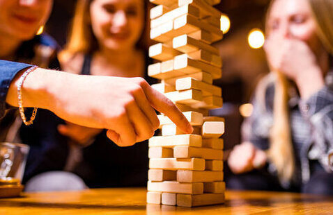 A group of people playing Jenga