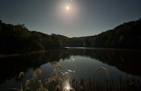 A full moon rises over Lake Ogle.