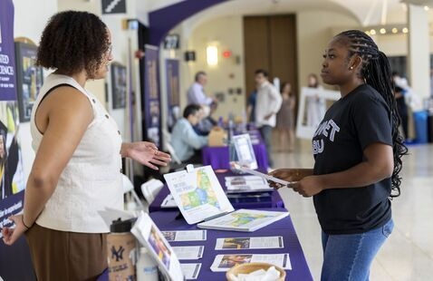 Student learning about service opportunities on the uptown campus.