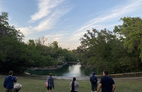 students visiting Wekiva Springs State Park with water and trees and sky