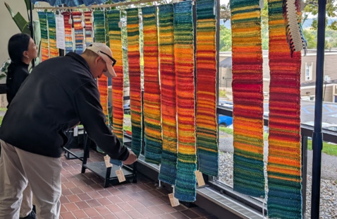 Colgate faculty and staff view sample Tempestries, during the project founders’ September visit to campus