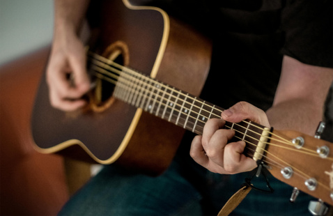 Person playing a guitar. 