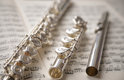 Flute resting on top of sheet music