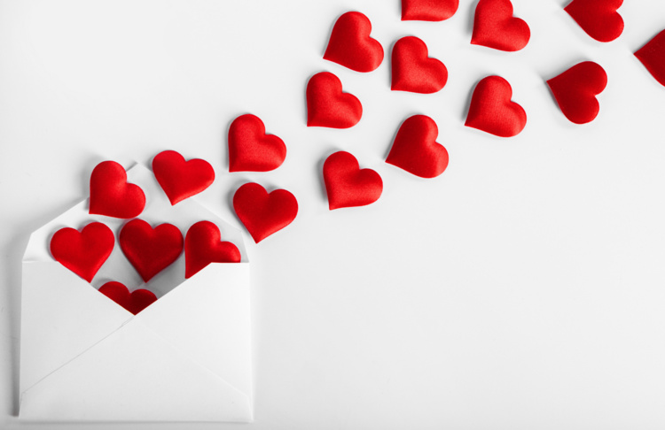 A picture of hearts coming out of  an envelope.
