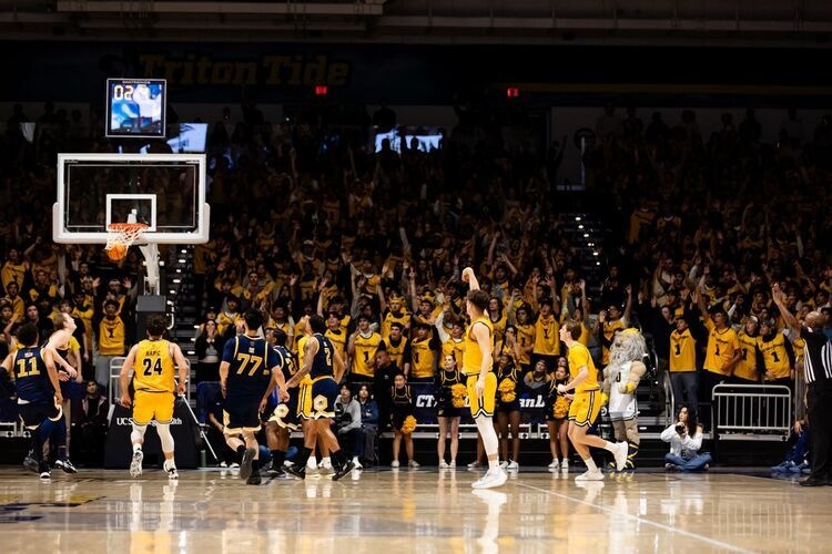 Triton basketball player makes a shot in front of crowd