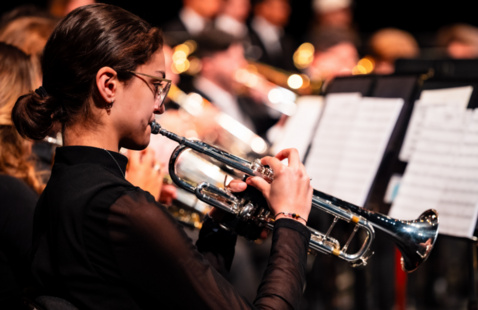 Student playing the trumpet in a band