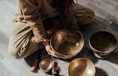 Person holding a brass meditation bowl