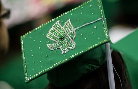 graduate wearing mortarboard with a diving eagle on it