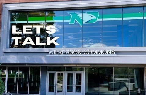 Front of wilkerson commons with text: Let's talk