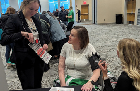 Person having blood pressure checked