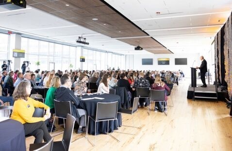 A crowd watches College of Arts and Sciences Dean Mike Madritch as he gives the welcoming remarks at the 2025 CAS Senior Awards Ceremony in the Grandview Ballroom at Appalachian State University.