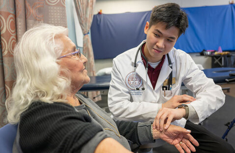 Physical Therapist Student takes pulse of female patient