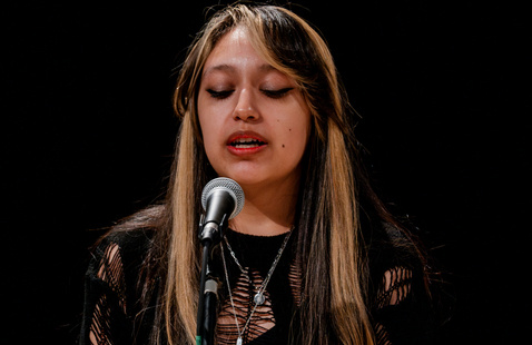 student singing with microphone