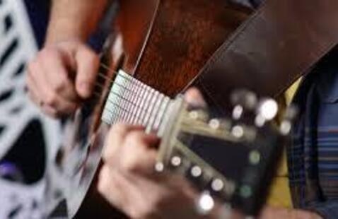 A man playing a guitar. 