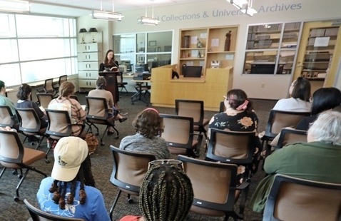 author speaking in front of crowd at event