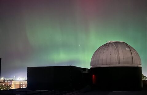 green and pink aurora over BGSU telescope dome