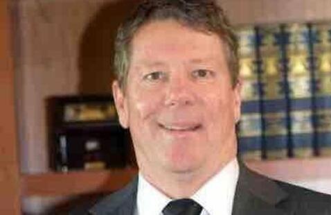 Jeff Bonnington with a bookcase just behind him.